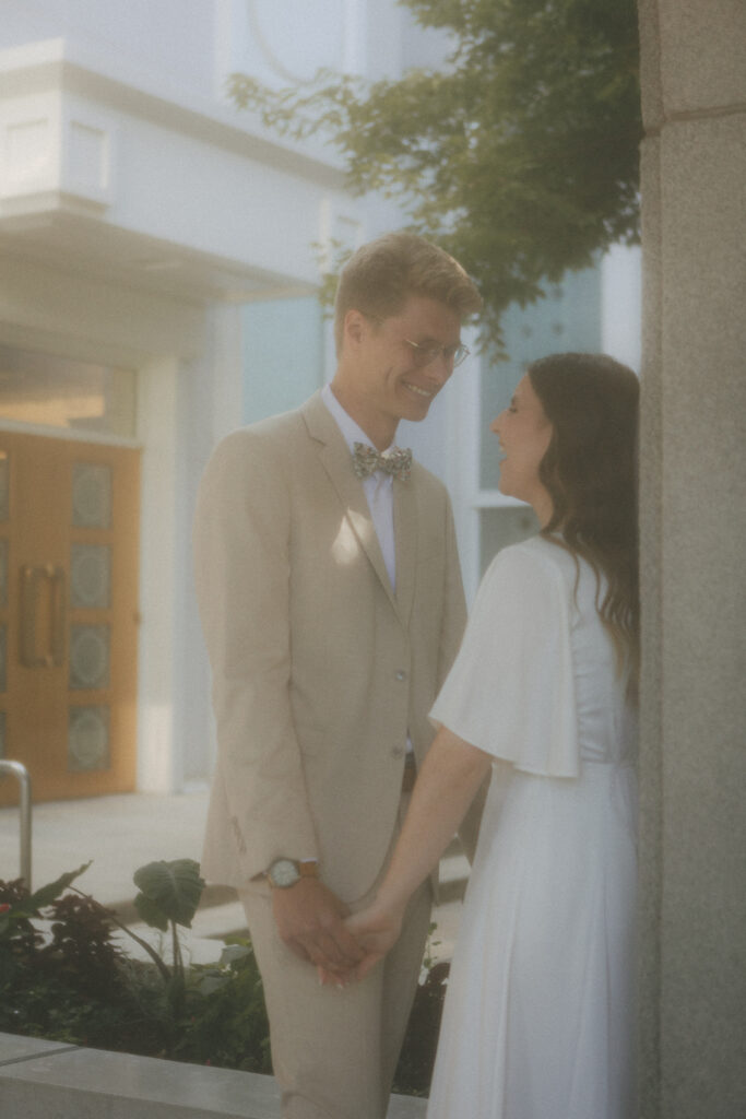 bride and groom looking into each other's eyes at temple