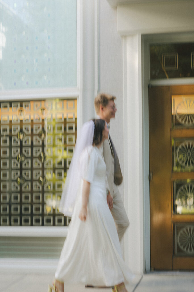 bride and groom walk by temple