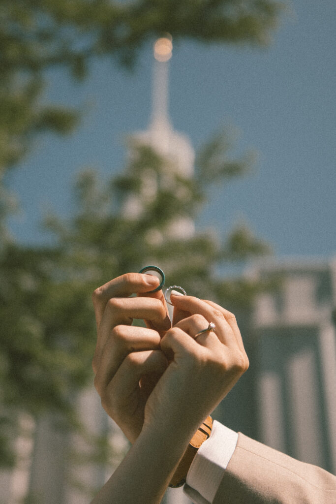 detail shot of wedding rings with temple behind