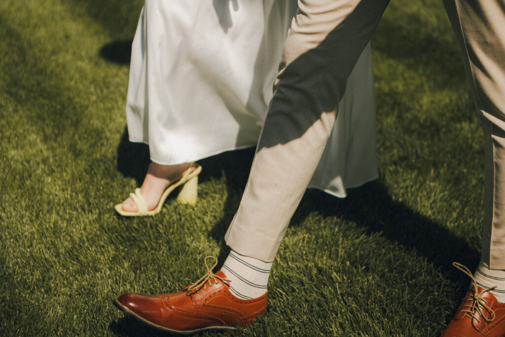 bride and groom walking across the temple grounds, detail shot of their shoes