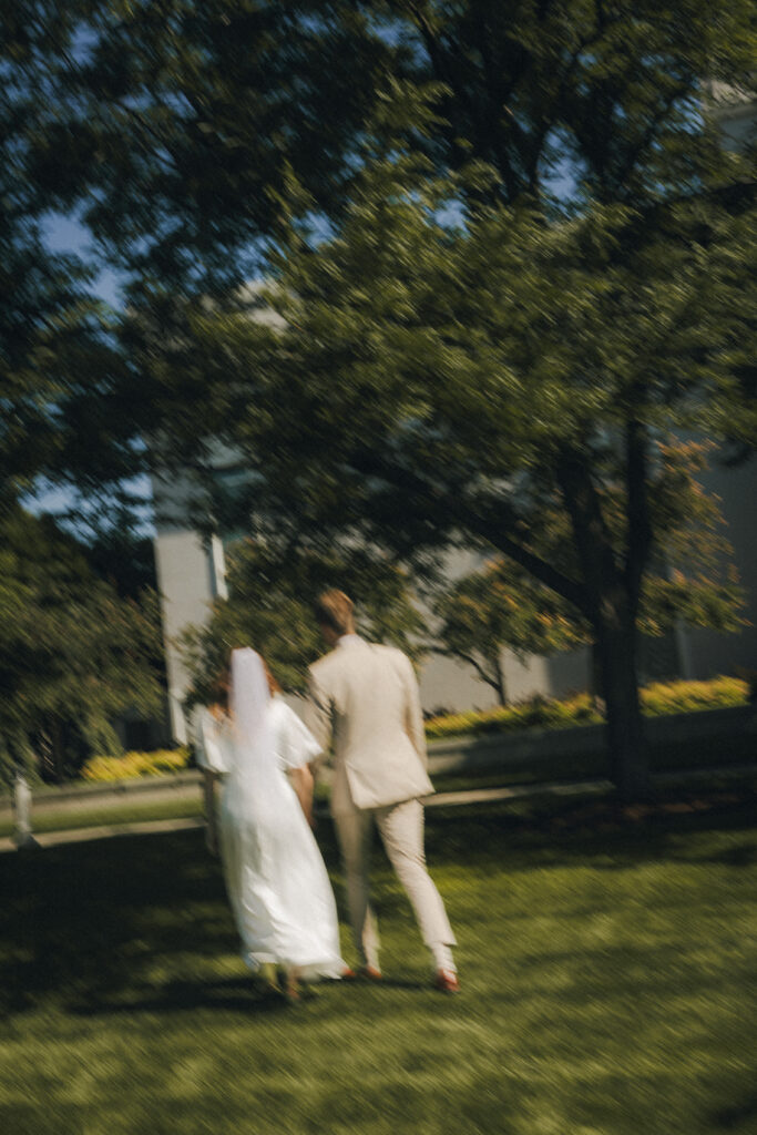 bride and groom walk across temple grounds