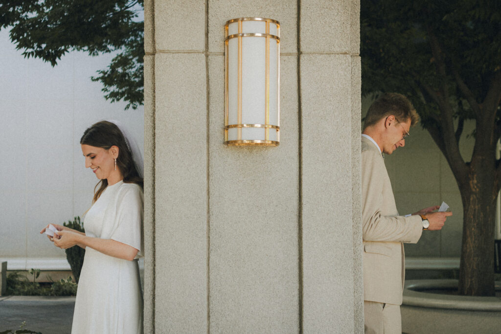 bride and groom reading love letter vows to each other