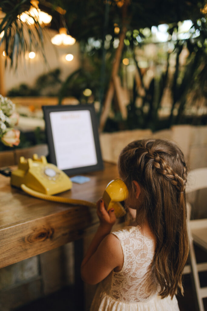 reception guest leaves a message on the phone for the bride and groom