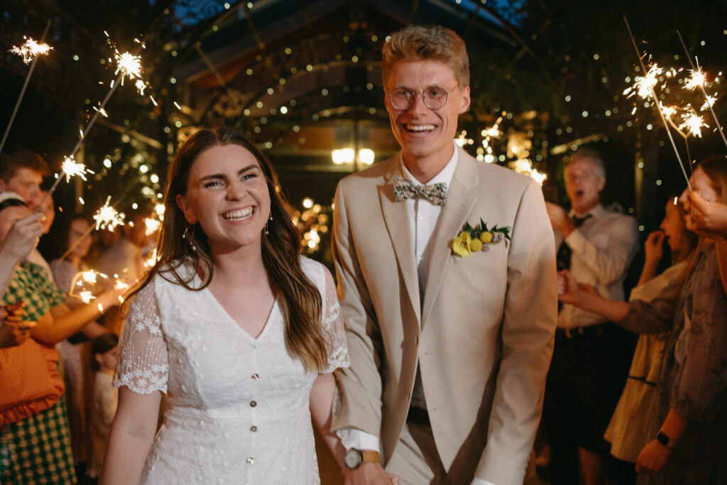 couple smiling, sparkler exit