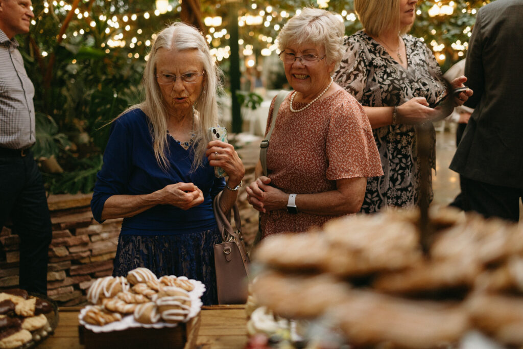 guests look at the yummy wedding reception treats
