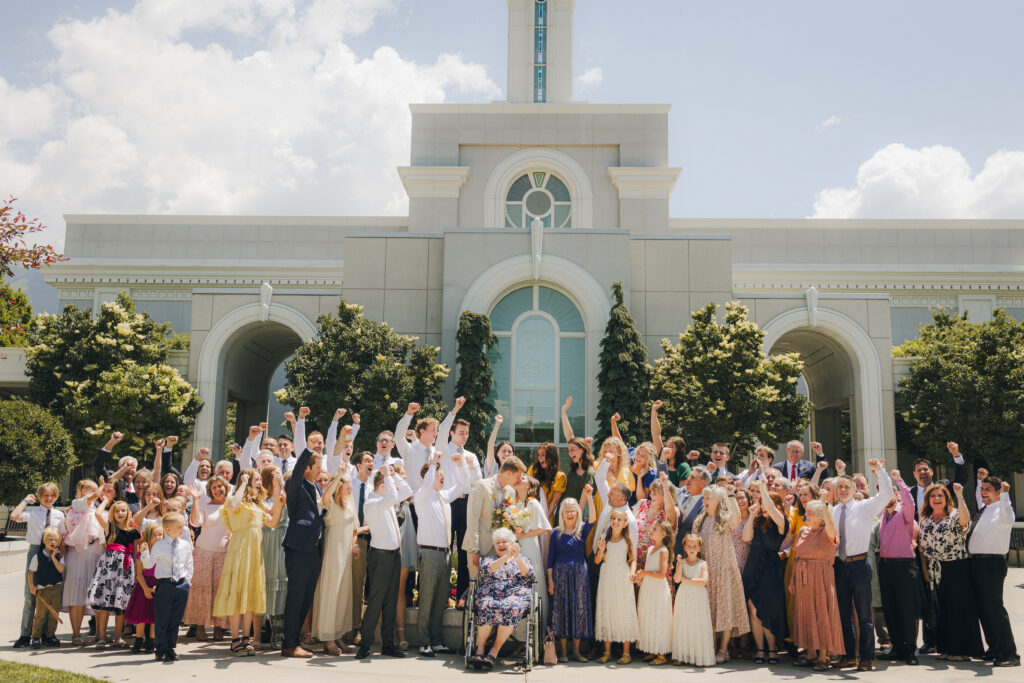 group photo of the wedding party outside the temple
