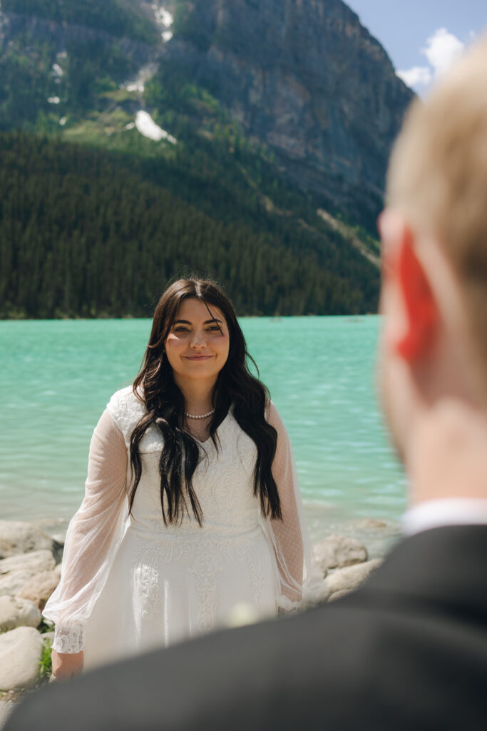 bride looks at groom during bridals at lake louise