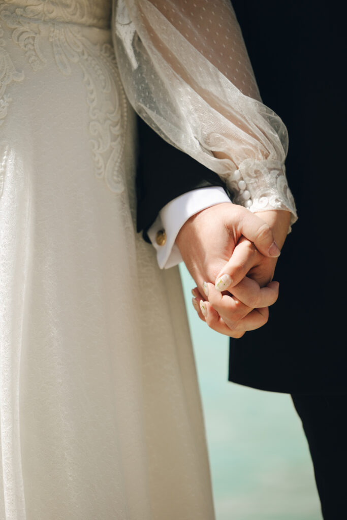 hand holding at blue mountain lake