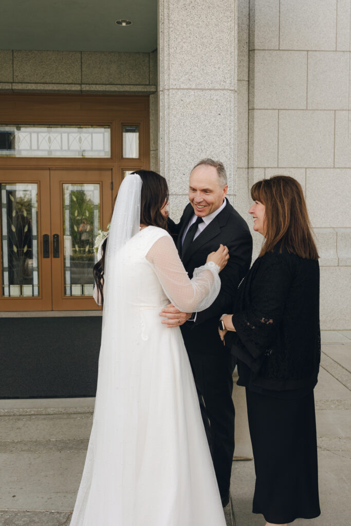 bride and groom greeting family