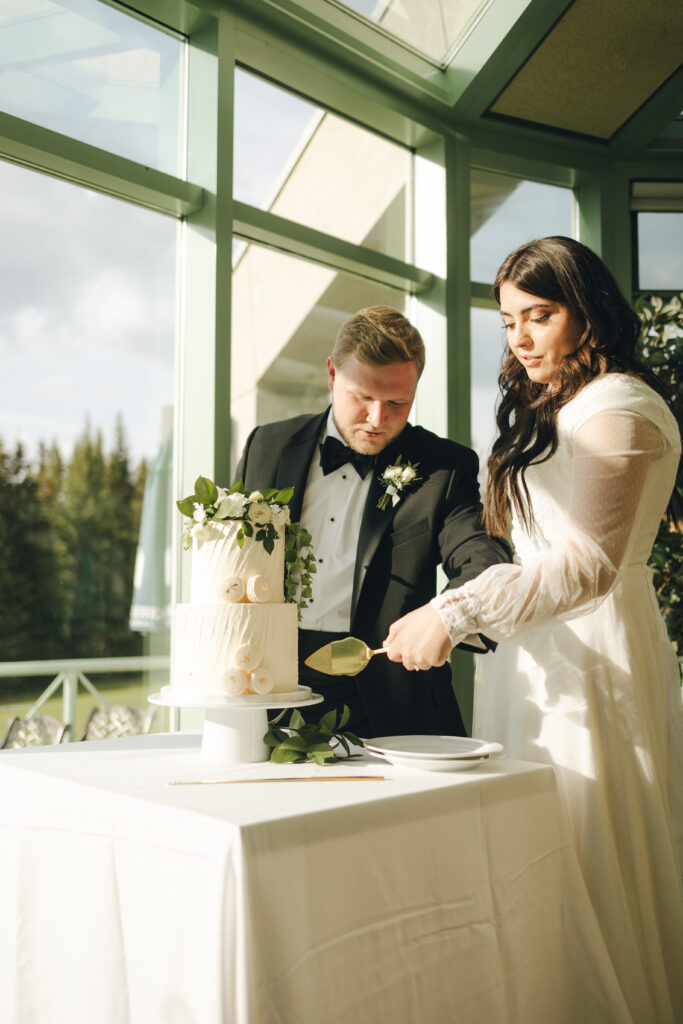 bride and groom cutting the cake