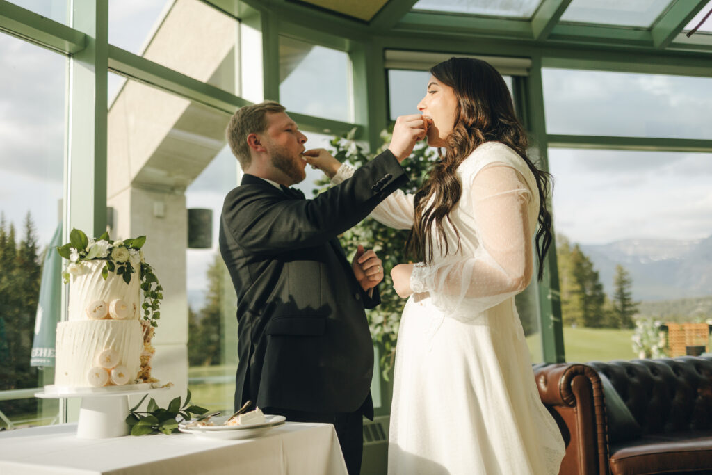 bride and groom feeding each other cake