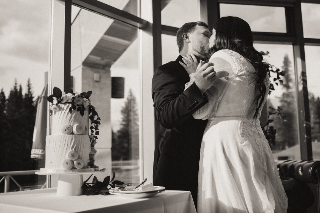 bride and groom kissing after cake cutting