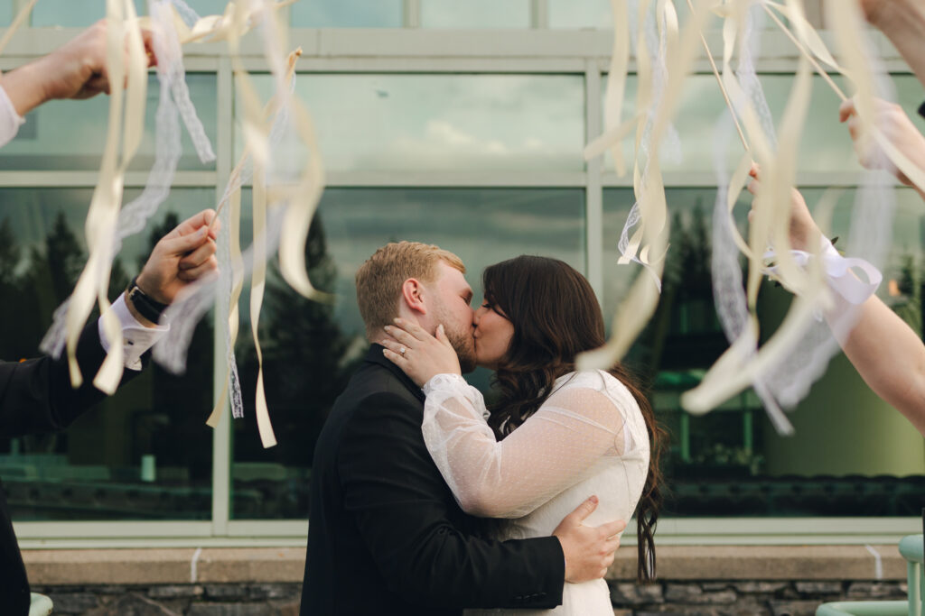 bride and groom exit with streamers